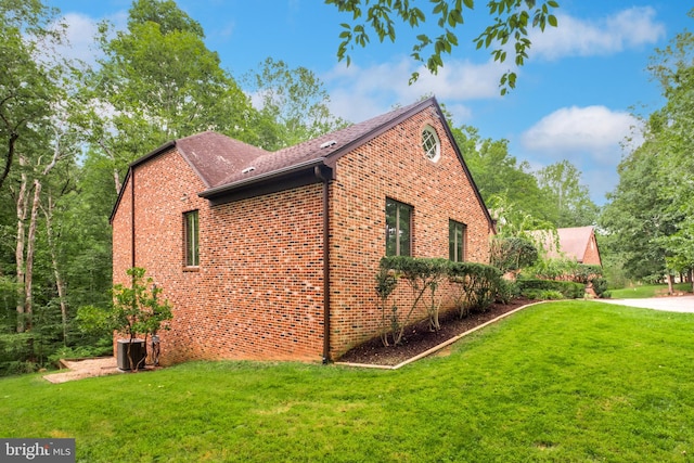 view of side of home with a lawn