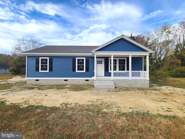 view of front facade featuring crawl space, covered porch, and roof with shingles