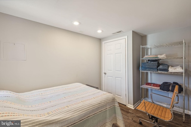 bedroom with dark hardwood / wood-style flooring