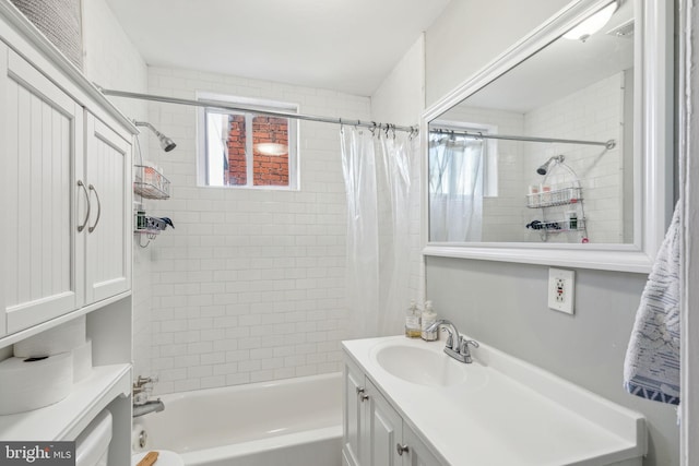 bathroom with shower / bath combination with curtain, vanity, and a healthy amount of sunlight