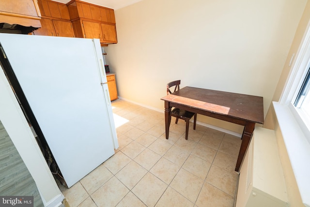 kitchen featuring light tile patterned flooring and white fridge