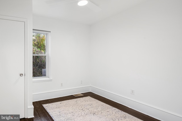 unfurnished room with dark hardwood / wood-style flooring