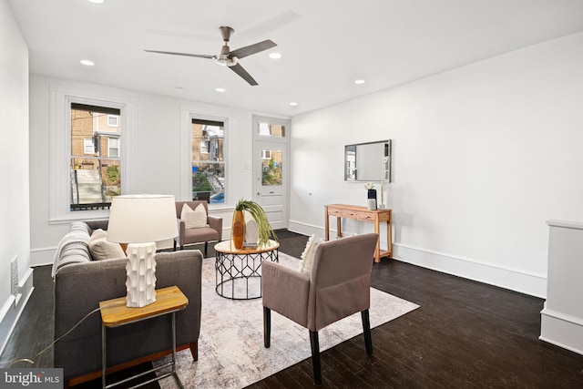 living room with dark hardwood / wood-style floors and ceiling fan