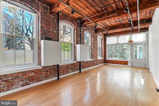 unfurnished sunroom with beam ceiling and wood ceiling