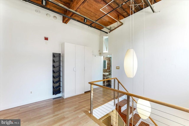 interior space featuring hardwood / wood-style floors and a towering ceiling