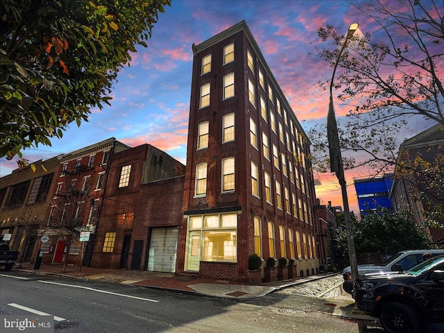 view of outdoor building at dusk