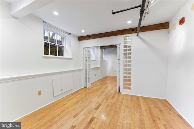 interior space with beamed ceiling and light wood-type flooring