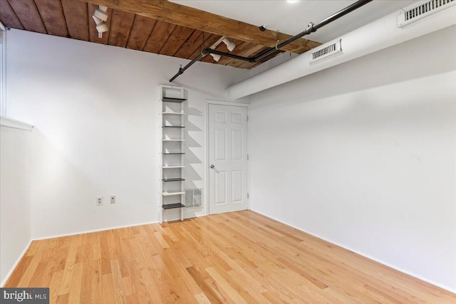 basement featuring hardwood / wood-style floors and wooden ceiling