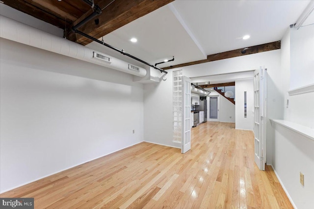 basement with light hardwood / wood-style flooring