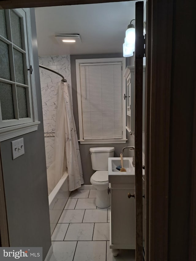 full bathroom featuring toilet, shower / bath combo, vanity, and tile patterned floors