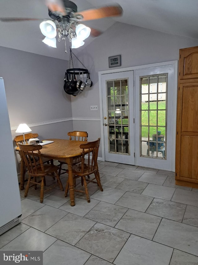 dining space with ceiling fan and lofted ceiling