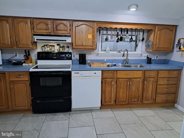 kitchen with sink, white appliances, and range hood