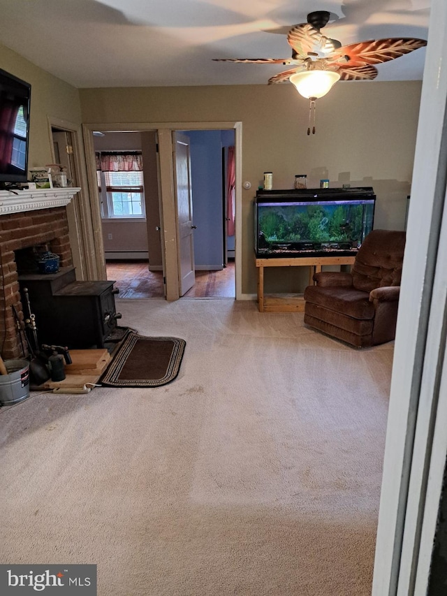 living room with ceiling fan, carpet flooring, and baseboard heating