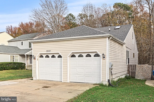 exterior space with a garage and a front lawn