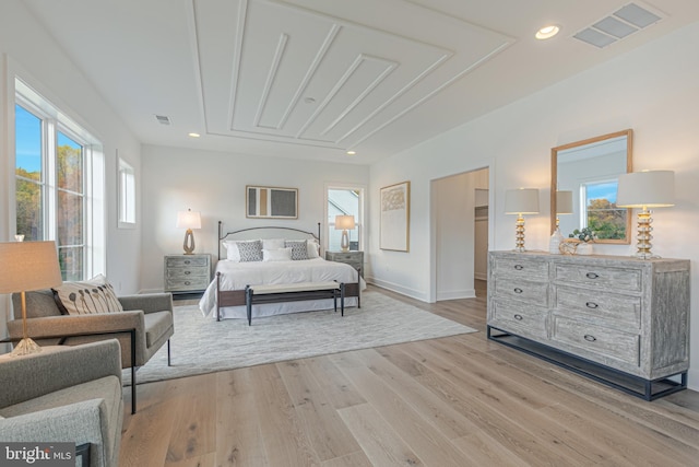 bedroom with multiple windows, light wood-style floors, baseboards, and recessed lighting