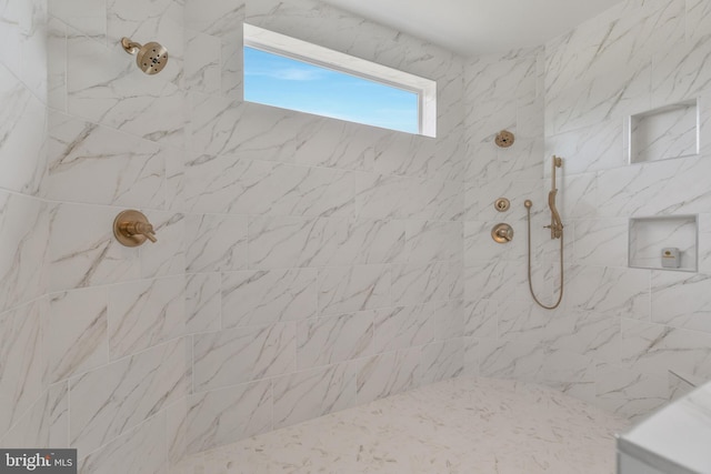 full bath with tiled shower