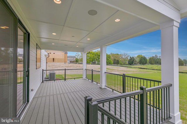 deck with a porch and a yard