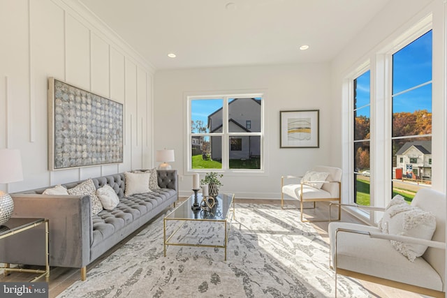 living room with wood finished floors, baseboards, and recessed lighting