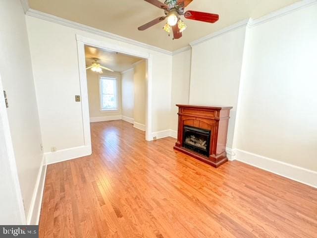 unfurnished living room with ornamental molding, ceiling fan, and light hardwood / wood-style flooring