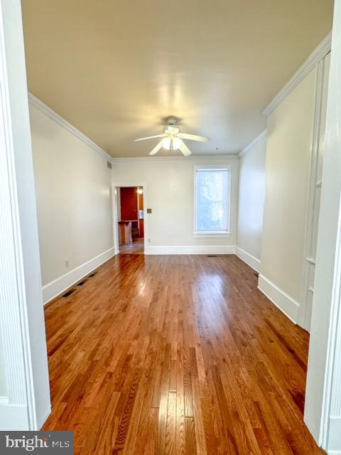 interior space with hardwood / wood-style flooring, crown molding, and ceiling fan