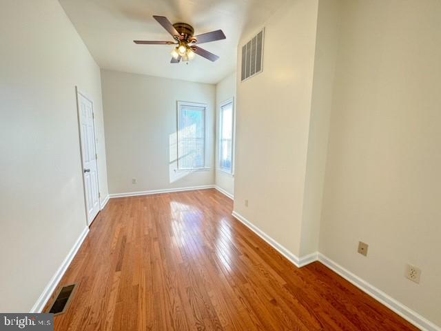 unfurnished room featuring light hardwood / wood-style floors and ceiling fan