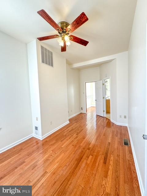 empty room featuring ceiling fan and light hardwood / wood-style floors