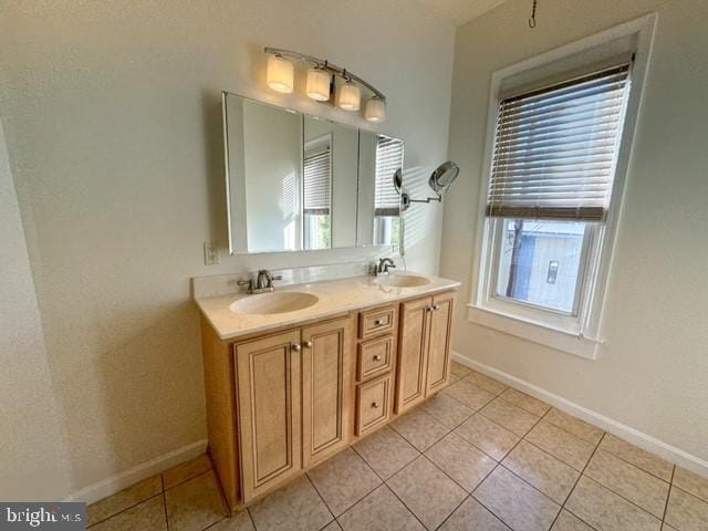 bathroom featuring a wealth of natural light, vanity, and tile patterned floors