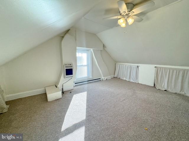 additional living space with carpet, lofted ceiling, ceiling fan, and heating unit