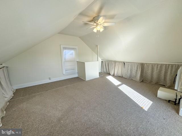 bonus room featuring light colored carpet, ceiling fan, and vaulted ceiling