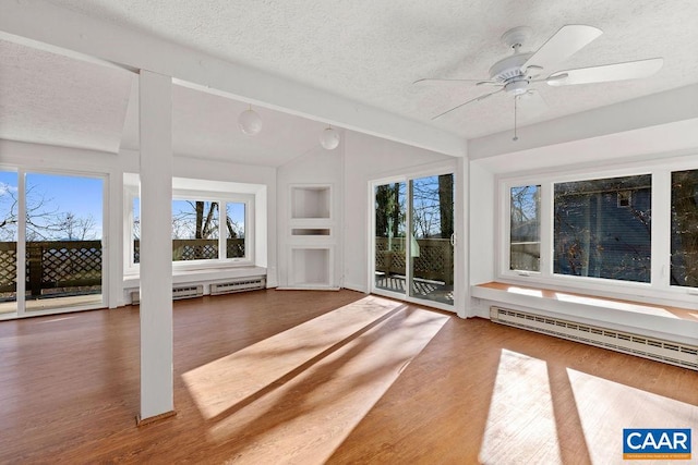 unfurnished sunroom with lofted ceiling with beams, a wealth of natural light, baseboard heating, and ceiling fan