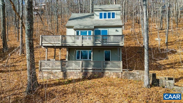 back of property with a balcony