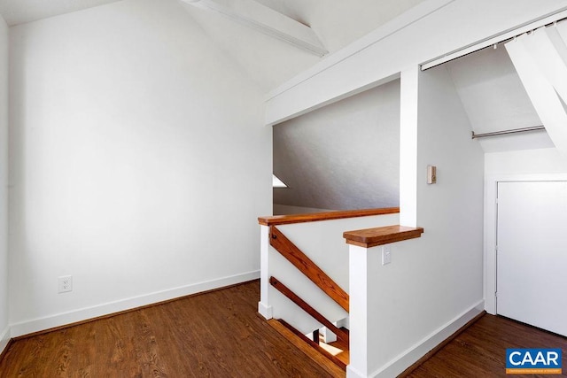 stairway featuring wood-type flooring and lofted ceiling