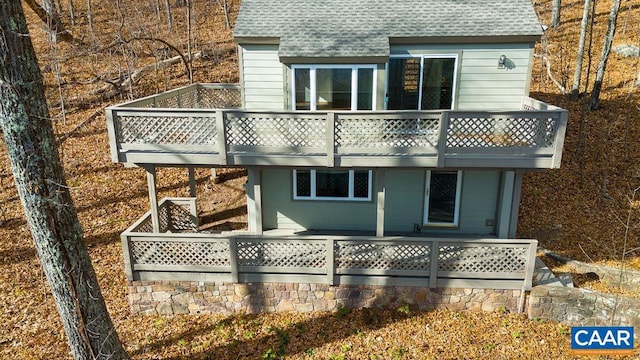 rear view of property featuring a deck