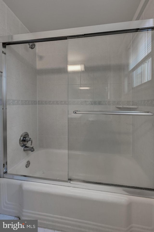 bathroom featuring shower / bath combination with glass door