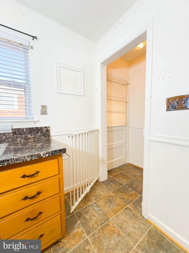 1336 30th St SE, Washington, DC 20020 - kitchen with dark stone counters, dark stone finish floors, and baseboards