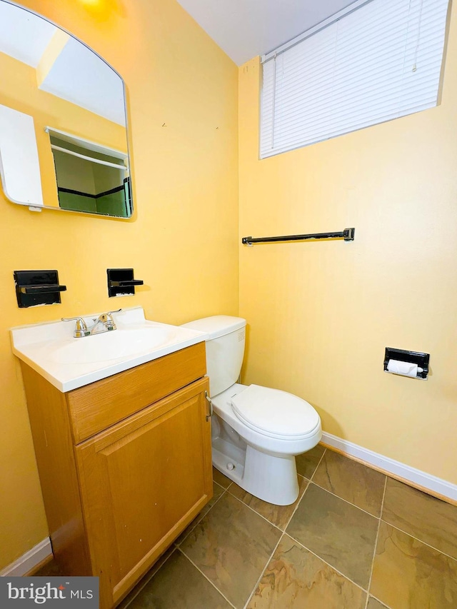 bathroom featuring tile patterned floors, vanity, and toilet