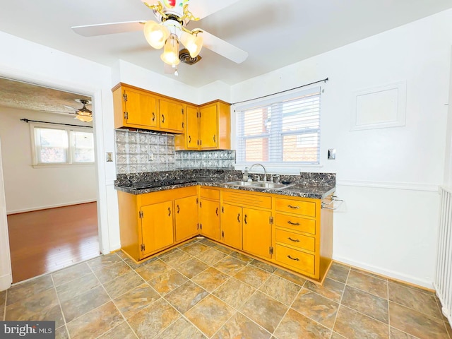 kitchen with ceiling fan, sink, and tasteful backsplash