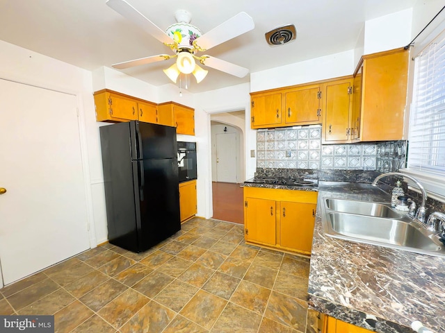 kitchen with sink, backsplash, ceiling fan, and black appliances