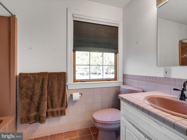 bathroom featuring tile walls, tile patterned flooring, vanity, and toilet