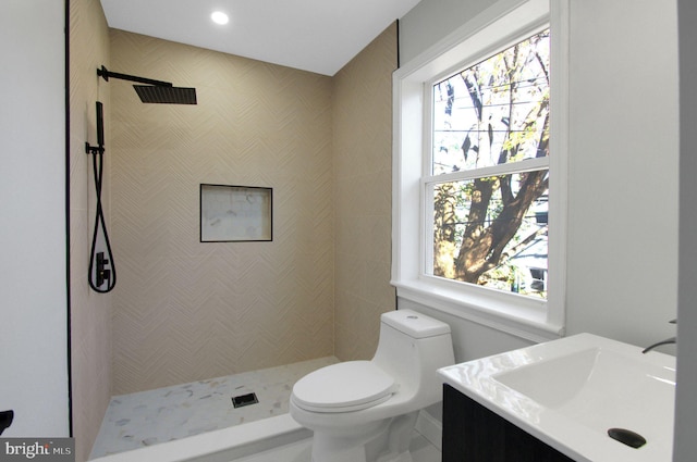 bathroom with vanity, toilet, walk in shower, and a wealth of natural light