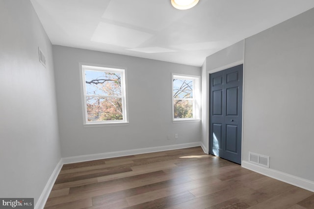 spare room with dark hardwood / wood-style floors