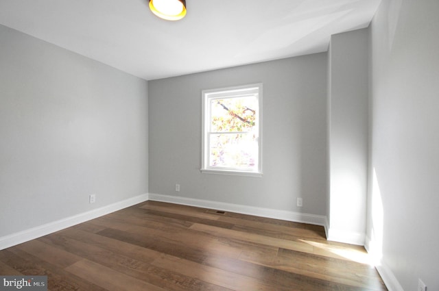 empty room featuring dark hardwood / wood-style flooring