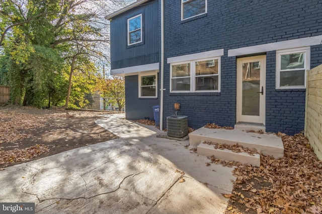 back of house with a patio area and central AC unit