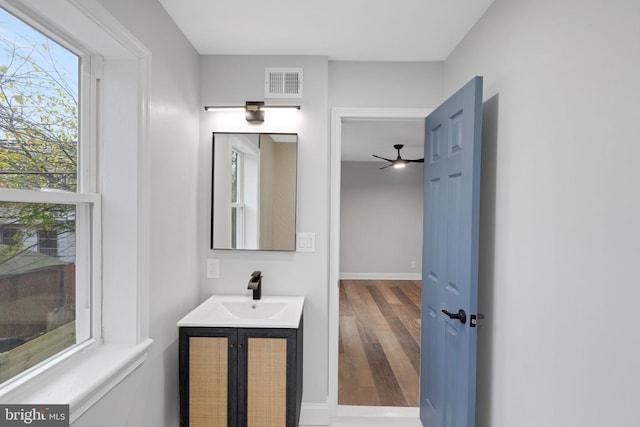 bathroom with ceiling fan, vanity, and hardwood / wood-style flooring