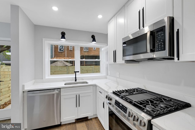 kitchen with white cabinets, sink, and stainless steel appliances