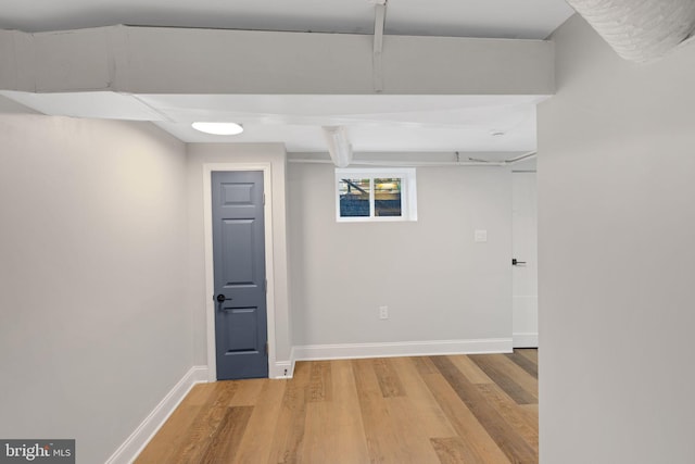 basement with hardwood / wood-style floors