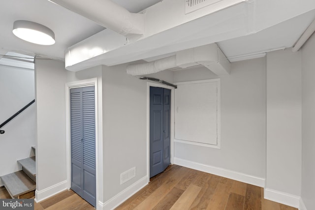 basement with hardwood / wood-style flooring