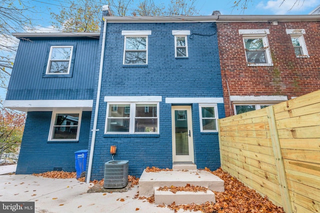 rear view of house with central AC unit