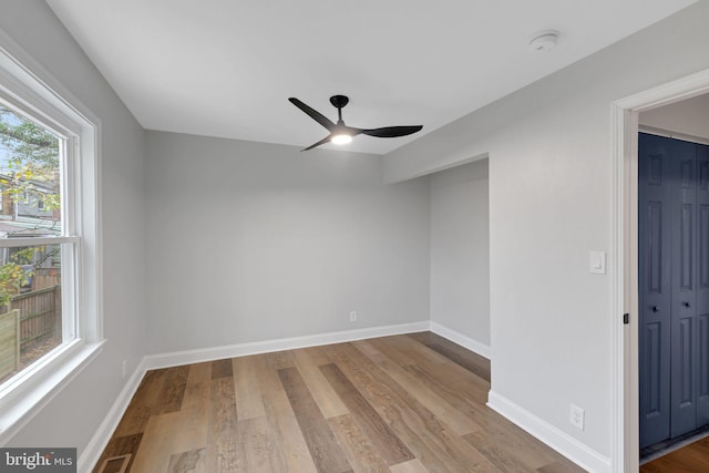 empty room with ceiling fan and light wood-type flooring