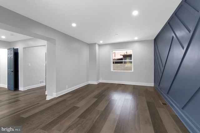 spare room featuring dark hardwood / wood-style flooring